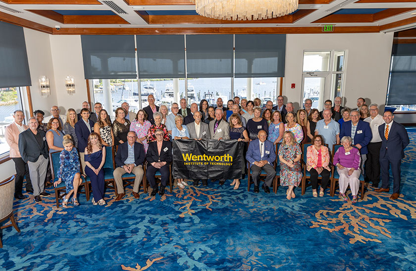 Photo of a large group of people holding a banner. Links to Tangible Personal Property
